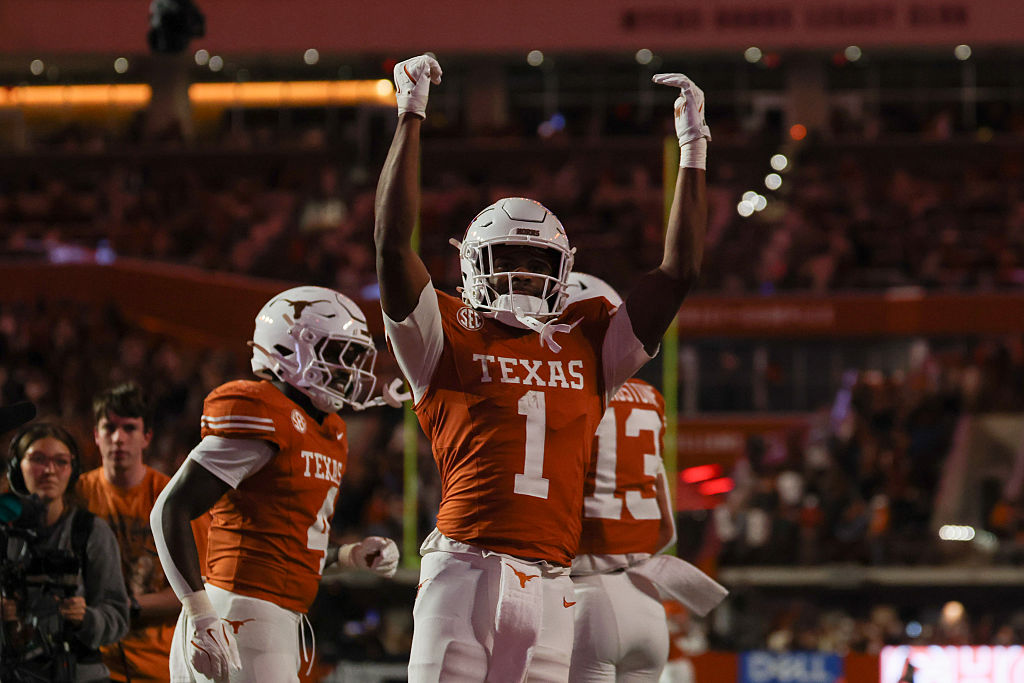 Texas Longhorns football players celebrating on the field